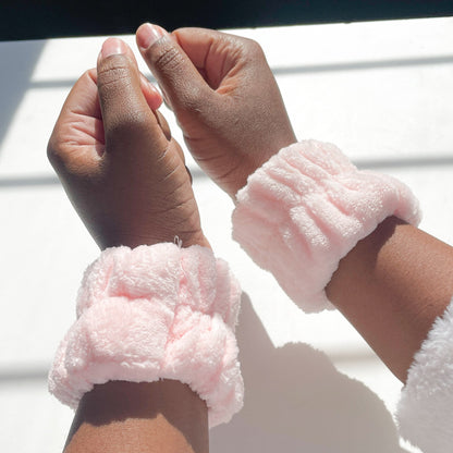 pink face wash wristbands on hands 